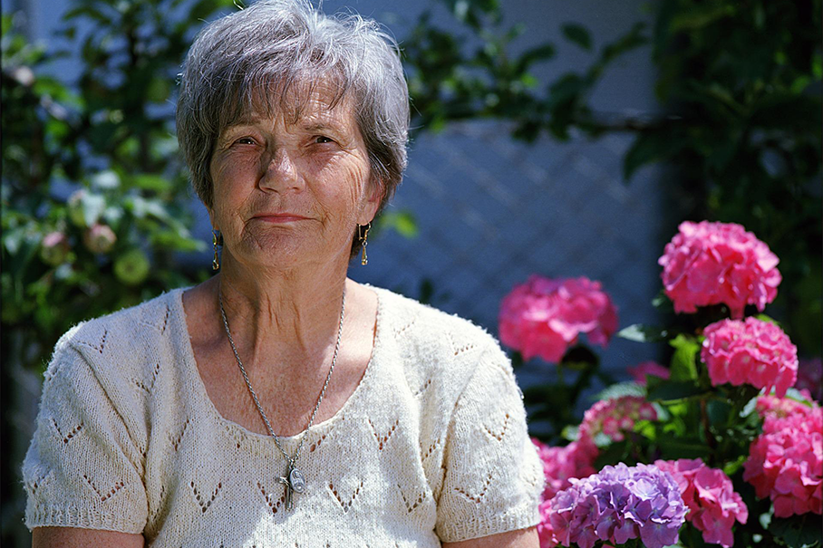 Elderly person sitting in garden
