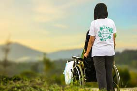 Deputyship order - a carer with a person in a wheelchair in front of a beautiful view
